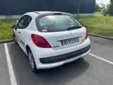a small white car that is parked in a parking lot