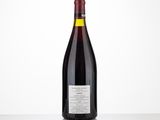 a bottle of red wine sitting on top of a table