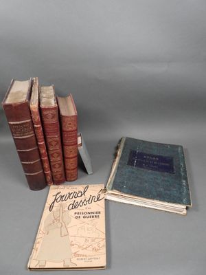 several old books are sitting on a table next to each other