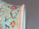 a blue vase with a floral design on it