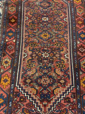 a close up of a rug on a wooden floor next to a wall