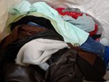 a pile of clothes in a plastic bag on the floor