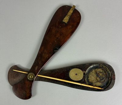 two wooden paddles that are attached to each other