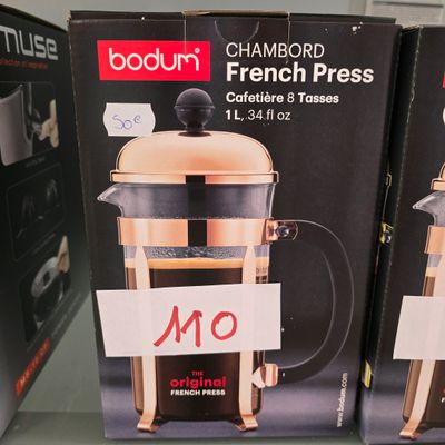 two boxes of french press coffee on a shelf in a store
