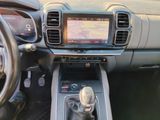 the interior of a car with a steering wheel and dashboard controls