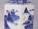 blue and white porcelain vase with a landscape scene on the lid