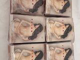 six boxes of assorted figurines of a woman in a dress