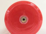 a red frisbee that is sitting on a white surface