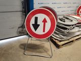 several red and white signs sitting on top of a pallet in front of a wall