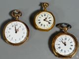 two gold pocket watches with roman numerals and roman numerals on them