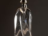 a glass bottle that is sitting on a table