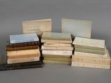 several old books stacked on top of each other on a table