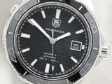 a close up of a watch on a white surface