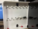 a white box with a bunch of black and red items in it