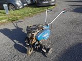 a small lawn mower that is sitting on the ground