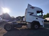 a white semi truck parked in a parking lot
