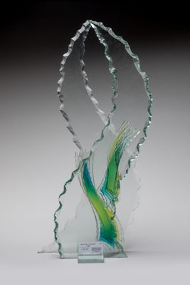 une photo d'une sculpture en verre représentant un oiseau posée sur un socle