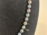 a close up of a necklace on a mannequin display