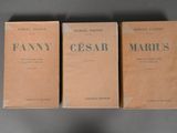three boxes of perfume sitting on top of a table next to each other