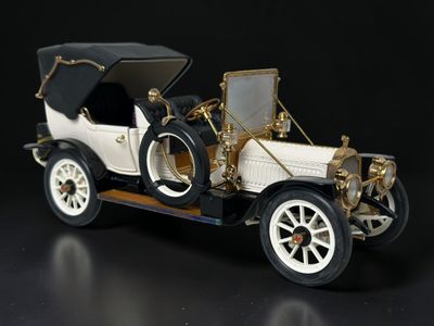 a small model of a car on a black surface