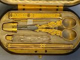 a case that has a set of gold colored items in it