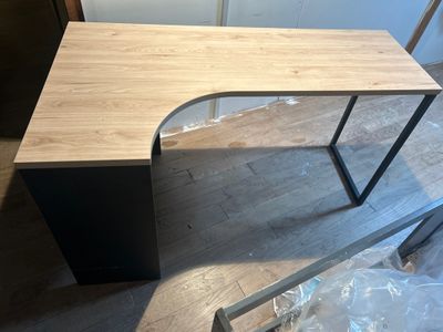 the desk is made of wood and has a metal frame