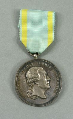 a close up of a medal with a ribbon around it
