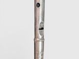 a silver pen that is sitting on top of a table