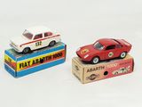 two toy cars are sitting on top of boxes on a white surface