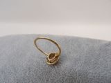 a close up of a gold ring with a knot on it