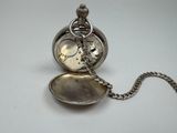 a silver pocket watch with a chain attached to it