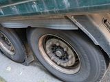 a green truck that is parked on the side of the road