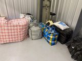 many bags of luggage sitting on the floor in a storage area