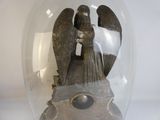 a statue of an angel in a glass dome on a table