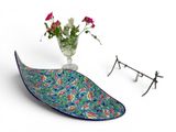a glass bowl with a flower in it next to a branch