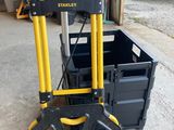 un diable jaune et noir équipé d'une boîte à outils à l'arrière