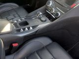 the interior of a car with black leather seats and dashboard controls