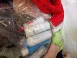 a person holding a bag full of items that are wrapped in plastic