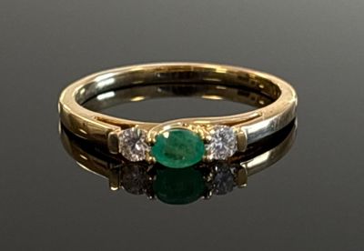 an image of a close up of a ring with a green stone