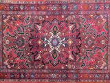 a red rug with a medallion design on it