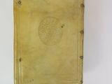an old yellow book sitting on top of a white table