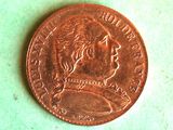 a close up of a penny on a green surface
