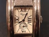 a silver wrist watch with roman numerals on it