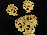 a pair of gold plated brooches and earrings