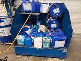 un conteneur bleu rempli de conteneurs bleus et blancs, à côté d'un tonneau bleu
