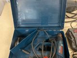 a blue tool box with a drill and other tools in it