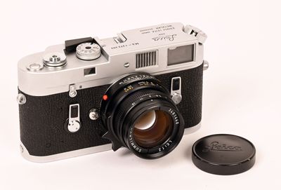 a black and white photo of a camera and a lens