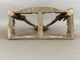 a small wooden bench with a decorative design on it