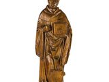 une image représentant une statue en bois d'un homme tenant un livre