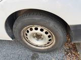 a white car that has a flat tire on it